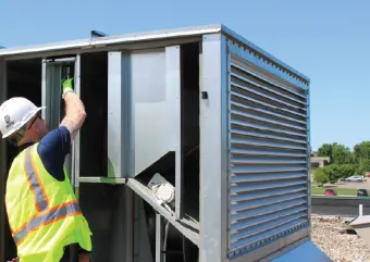 A contractor working on a rooftop unit. 