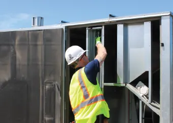 A contractor working on a rooftop unit. 